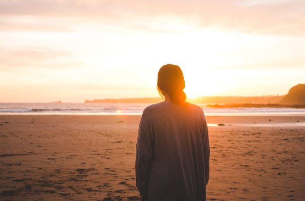 photo of a woman watching the sunrise